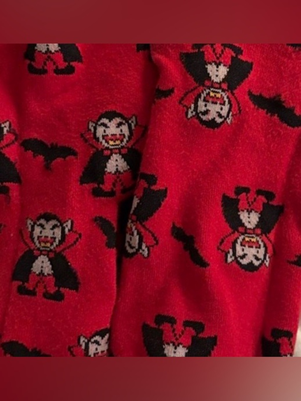 Red socks featuring Dracula, Black bats and Accents in Yellow, Gray.